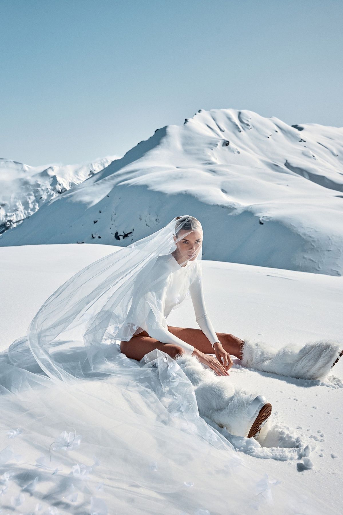 A fashion portrait in a snowy alpine landscape